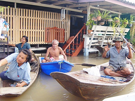 With their homes inundated, people need to use boats instead of cars.